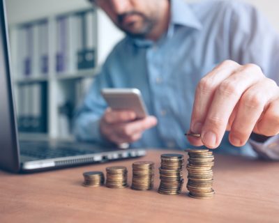 Finances and budgeting, businessman stacking coins